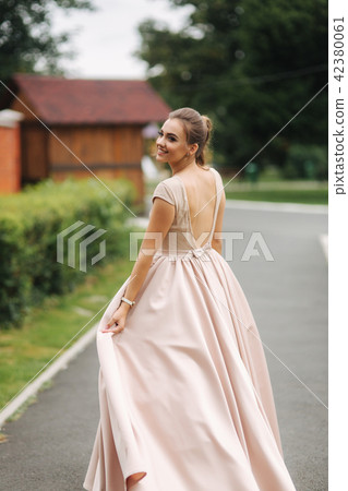 Young stylish model poses to photographer outside Young stylish model poses to photographer outside 42380061