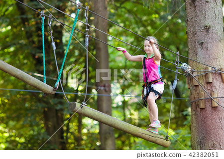 Child in adventure park. Kids climbing rope trail. Child in adventure park. Kids climbing rope trail. 42382051