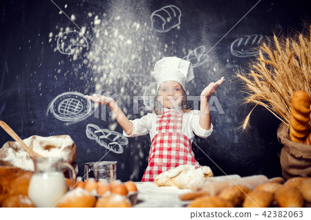Playful little girl throwing flour powder Playful little girl throwing flour powder 42382063