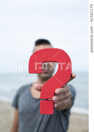 question mark in front of the face of a person 42382179
