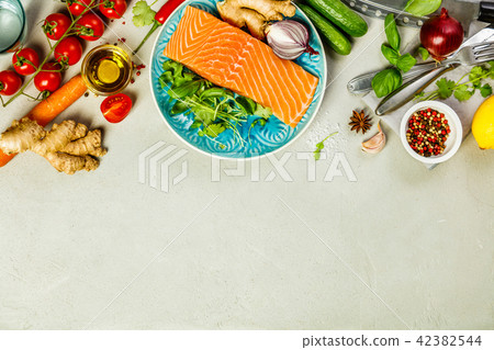 Raw salmon fillet and ingredients for cooking Raw salmon fillet and ingredients for cooking 42382544