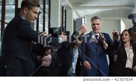 Politician escaping from nosy journalists 42387034