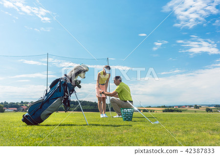 Full length of an experienced instructor teaching a young woman Full length of an experienced instructor teaching a young woman 42387833
