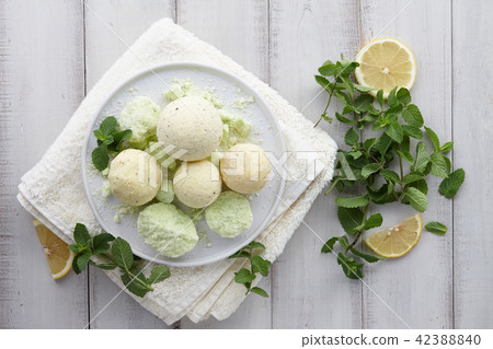 Handmade mint bath bombs and towel on white planks 42388840