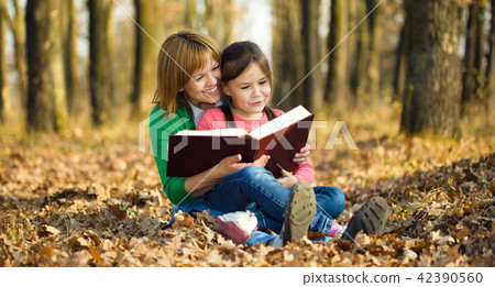 Mother is reading book with her daughter Mother is reading book with her daughter 42390560