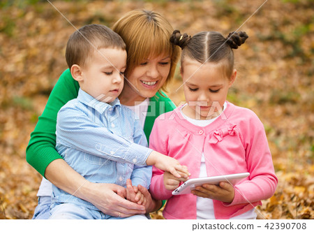 Mother is reading book with her daughter and son Mother is reading book with her daughter and son 42390708