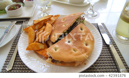 PULAU LANGKAWI, MALAYSIA - APR 4th 2015: Chicken focaccia sandwich with potato wedges PULAU LANGKAWI, MALAYSIA - APR 4th 2015: Chicken focaccia sandwich with potato wedges 42391876