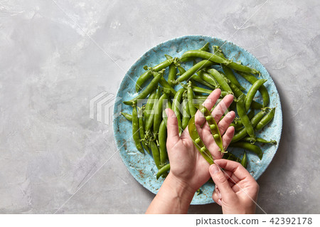 Pear sticks on blue ceramic plate on gray concrete table stick of pea, which cleans or opens the 42392178