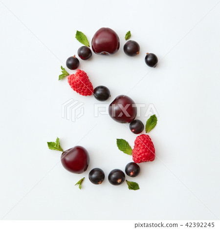 Flat lay pattern of letter S english alphabet from natural ripe berries - black currant, cherries 42392245