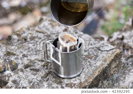 Making coffee on the street. 42392295