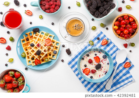 Photo of Viennese waffles, oatmeal, coffee, raspberries, strawberries, gooseberries 42392481
