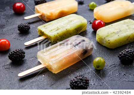 Photo on top of ice cream on stick, blackberry,cherry, gooseberry Photo on top of ice cream on stick, blackberry,cherry, gooseberry 42392484