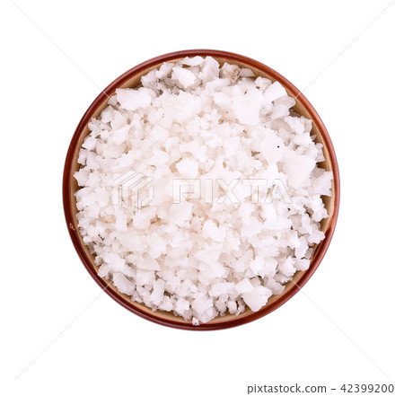 Sea salt in bowl on white background Sea salt in bowl on white background 42399200