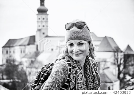 Tourist woman posing with Mikulov castle colorless 42403933