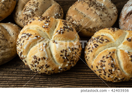 Different bread on a rustic wooden background. Different bread on a rustic wooden background. 42403936