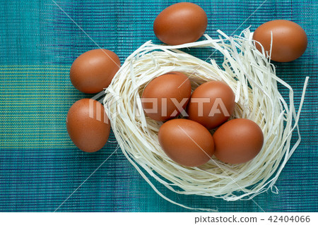 Eggs lie on the decor in the form of a nest. Eggs lie on the decor in the form of a nest. 42404066