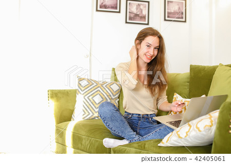 journalist female using laptop bank card to book tickets. journalist female using laptop bank card to book tickets. 42405061