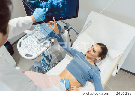 Doctor gynecologist and woman in ultrasonic pregnancy test 42405285