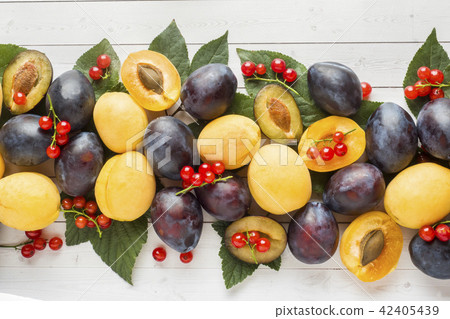 Fresh plum, apricot and red currant berries 42405439