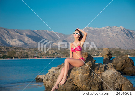 girl in sunglasses and bikini on Elafonissi beach 42406501