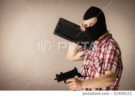 Man in balaclava holding keyboard and gun 42406521