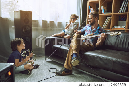 Children play with their dad musical instruments. Children play with their dad musical instruments. 42406859