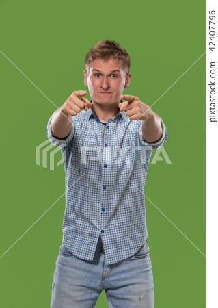 The overbearing businessman point you and want you, half length closeup portrait on green background 42407796