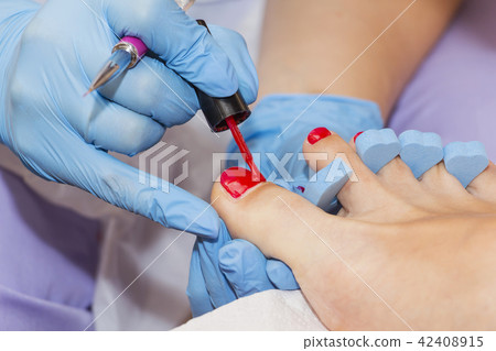 Woman feet receiving pedicure. Close up concept. 42408915