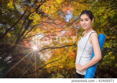 Young asian woman holding her yoga mat 42408971
