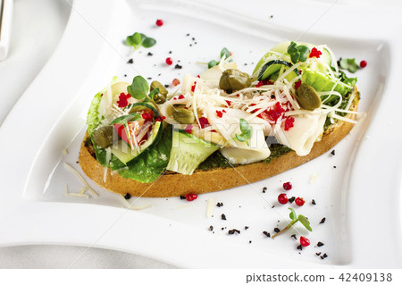 Bruschetta with pesto sauce, fish, fresh vegetable Bruschetta with pesto sauce, fish, fresh vegetable 42409138