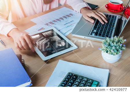 Business woman working with tablet and book Business woman working with tablet and book 42410977