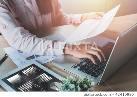 Businesswoman analyzing investment charts Businesswoman analyzing investment charts 42410980