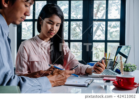 Mature businessman using a smartphone Mature businessman using a smartphone 42411002