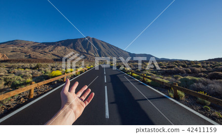 Straight asphalt road with hand invite on peak Straight asphalt road with hand invite on peak 42411159
