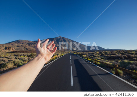 Straight asphalt road with hand invite on peak Straight asphalt road with hand invite on peak 42411160