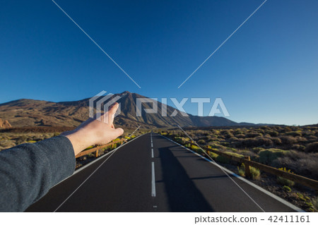 Straight asphalt road with hand invite on peak Straight asphalt road with hand invite on peak 42411161
