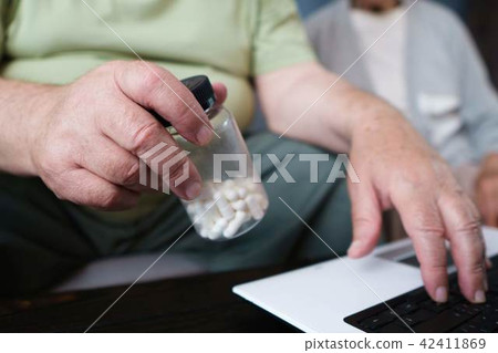 Senior man check prescription for medicine online Senior man check prescription for medicine online 42411869