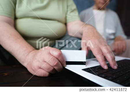 Senior couple shopping at online store Senior couple shopping at online store 42411872