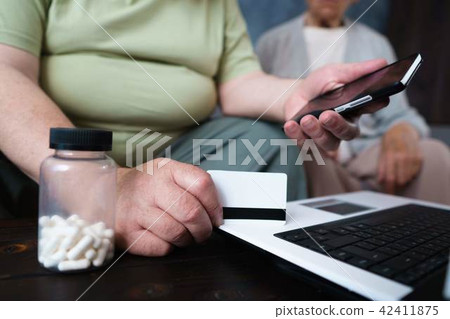 Senior couple doing online shopping using gadgets Senior couple doing online shopping using gadgets 42411875