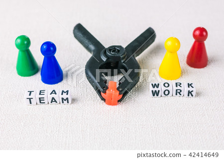 Team work concept - Figures form with clamp tool as symbol for a working labor team collaboration 42414649