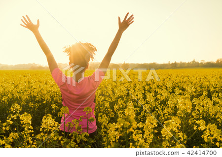Female Athlete Runner Celebrates In Yellow Flowers Female Athlete Runner Celebrates In Yellow Flowers 42414700