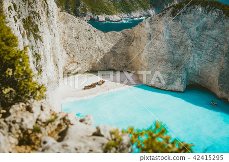 Famous shipwreck on Navagio beach with turquoise blue sea water surrounded by huge white cliffs 42415295