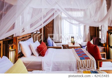 Bedroom interior four poster bed colourful fabric 42415485