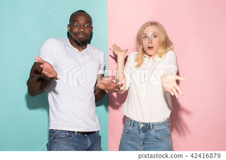 Closeup portrait of young couple, man, woman. One being excited happy smiling, other serious Closeup portrait of young couple, man, woman. One being excited happy smiling, other serious 42416879