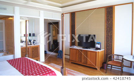 PULAU LANGKAWI, MALAYSIA - APR 4th 2015: Comfy bed in a luxury hotel suite at THE DANNA, colonial PULAU LANGKAWI, MALAYSIA - APR 4th 2015: Comfy bed in a luxury hotel suite at THE DANNA, colonial 42418745