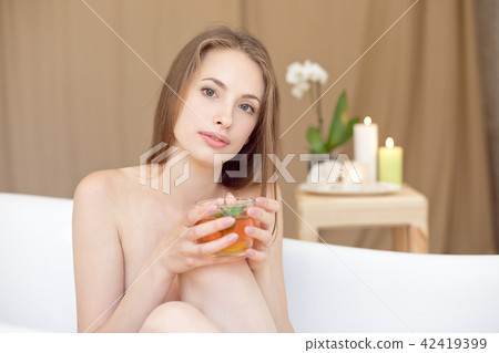 Caucasian smiling woman after spa covered with white towel 42419399
