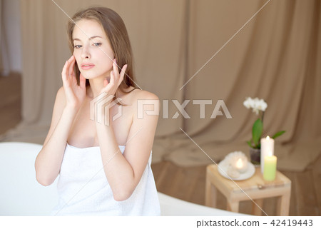 Caucasian smiling woman after spa covered with white towel Caucasian smiling woman after spa covered with white towel 42419443