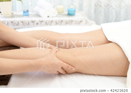 Women receiving leg massage Women receiving leg massage 42421620
