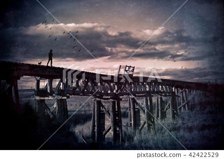 Man and dog walk across abandoned railway bridge Man and dog walk across abandoned railway bridge 42422529