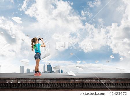 Concept of careless happy childhood with girl of school age looking in future Concept of careless happy childhood with girl of school age looking in future 42423672